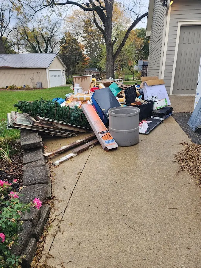 Dumpster being loaded with debris for Estate Cleanout Dumpster Rental in Eugene